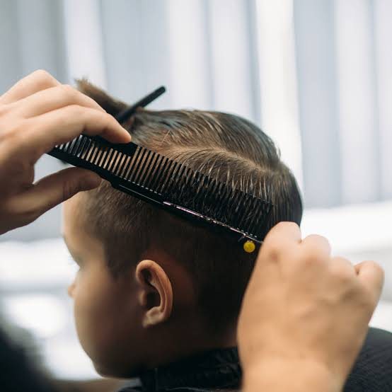 Comb and clipper detail during a child's haircut